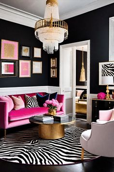 a living room with zebra print rugs and pink couches in front of a chandelier