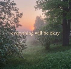 the words everything will be okay are displayed in front of trees and foggy grass