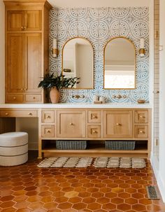 a bathroom with wooden cabinets and tile flooring, two mirrors on the wall above the vanity