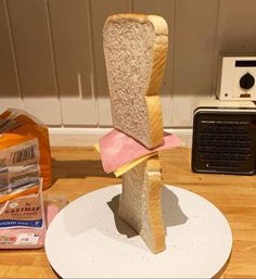 a piece of bread sitting on top of a white plate next to a toaster