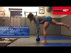 a woman is doing an exercise with a kettle in her hand and legs on the ground