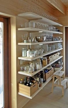 the shelves are filled with dishes and glasses