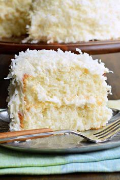 a close up of a slice of cake on a plate with a fork in front of it