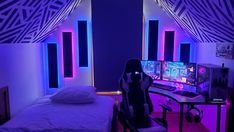 a room with two beds, a computer desk and neon lights