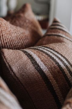 a close up view of some pillows on a bed