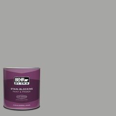 a can of behrut ultra stain - blocking paint on a grey background,