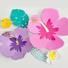 paper flowers are arranged on top of each other, with one flower cut out in the middle