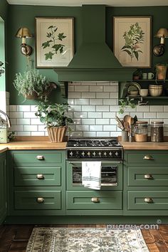 a kitchen with green painted cabinets and white subway backsplash, potted plants on the stove