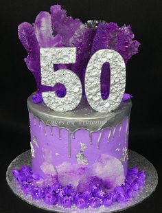 a purple and silver cake with the number 50 on it