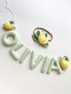 the word avoca written in felt with lemons and leaves hanging from it's sides