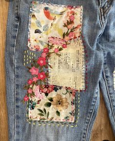 an old pair of jeans with flowers on them