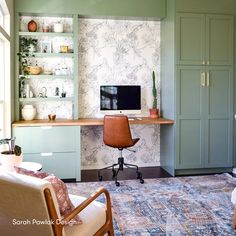 a living room filled with furniture and a flat screen tv sitting on top of a wooden desk