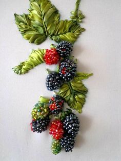 some berries and leaves are hanging on the wall