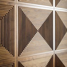 a wooden paneled wall with geometric designs on it