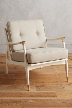 a white chair sitting on top of a hard wood floor