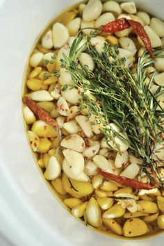 a white bowl filled with beans and herbs