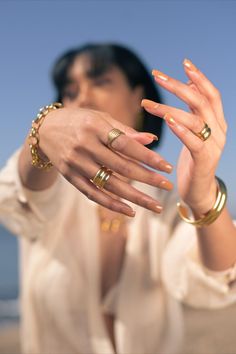 a woman with two gold rings on her fingers