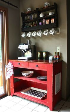 a red cabinet with coffee cups on it