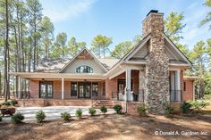 a brick house in the woods surrounded by pine trees