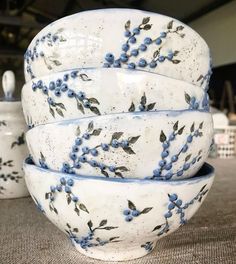 four blue and white bowls stacked on top of each other