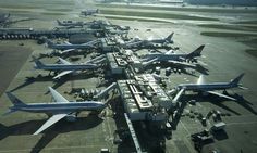 an airport filled with lots of airplanes parked next to each other