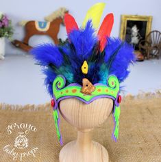 a wooden headdress with feathers on it