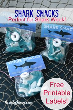 three shark snacks in plastic bags on a table with the text shark snacks perfect for shark week