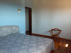 a bed sitting in the middle of a bedroom next to a wooden floor and wall