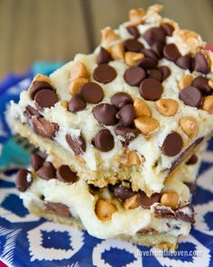 two pieces of chocolate chip cookie bars on a blue and white plate with a fork