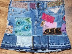 a patchwork denim skirt with colorful patches on it