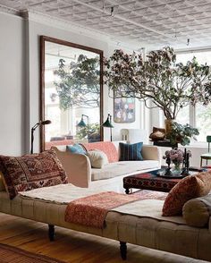 a living room filled with furniture and lots of windows