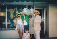 a group of people standing in front of a store