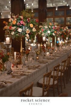 a long table with flowers and candles is set up for a formal dinner or function