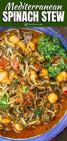 this easy spinach stew is packed with vegetables and pasta in a bright blue bowl