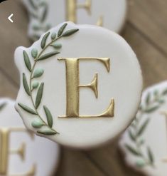 decorated cookies with the letter e and leaves on them are shown in close - up