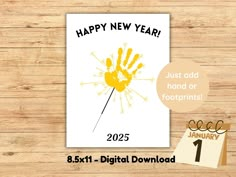 a happy new year card with handprints on it and a calendar next to it