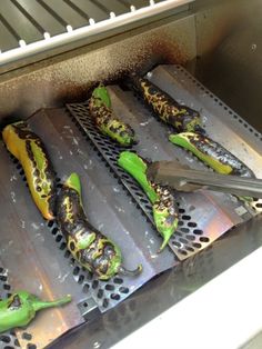 green peppers are being cooked on the grill