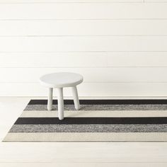 a small white table sitting on top of a rug