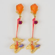 This is part of Chairish’s Costume Jewelry assortment.  These gorgeous Christian Lacroix Paris futuristic clip-on earrings feature a textured gilt metal framing, complimented with a long dangling and articulated design, ornate with hot pink enamel, and topped with orange, purple, and lavender crystal rhinestones. The piece is signed with a gilded tag at the back: Christian Lacroix - CL - made in France. Measurements: 1.13 in wide (2.8 cm) x 3.50 in high (8.9 cm).  Please see the measurements not Christian Lacroix Jewelry, Pink Enamel, Diamond Drop Earrings, Diamond Drops, Christian Lacroix, Modern Earrings, Clip Earrings, Crystal Rhinestone, Costume Jewelry