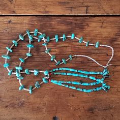 This beautiful turquoise necklace is 36.5" in length and has long, free moving beads that hang from the center of the necklace. This long turquoise necklace is lightweight and easily slips over the head for convenience. It is extremely comfortable.  It is most likely handcrafted from Morenci turquoise or Kingman turquoise beads, spaced with brown shell heishi beads.   We estimate this necklace to be made in the mid 1970's and is in good vintage condition. A single bead at the bottom of the turqu Adjustable Southwestern Turquoise Necklace Hand-strung, Southwestern Adjustable Turquoise Necklace Hand-strung, Southwestern Turquoise Necklace With Large Beads, Southwestern Turquoise Necklace For Festivals, Adjustable Southwestern Hand-strung Turquoise Necklace, Adjustable Single Strand Turquoise Bohemian Necklace, Southwestern Adjustable Hand-strung Turquoise Necklace, Southwestern Style Turquoise Necklace For Festivals, Southwestern Beaded Lariat Necklace