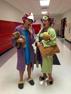 two women dressed in costumes standing next to each other with stuffed animals on their heads