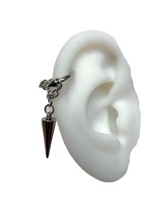 a white ear with a silver chain and a black triangle charm hanging from it's side