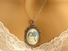 "Sterling Silver Mother Child Cameo Necklace, Victorian Blue Cameo, Mother and Child Cameo, Mother Mom Gift Idea, Victorian Cameo Jewelry I love the sweetness in this beautiful Victorian Mother/Child cameo necklace. The pendant is a neoclassical woman and child against a Williamsburg blue background. The cameo is framed in a reproduction Victorian antiqued silver plated brass setting and hangs on your choice of a sterling silver, rhodium (antiqued white gold) plated, or silver plated chain. Leng Blue Cameo Necklace For Wedding, Victorian Mother, Mother Child Necklace, Child Necklace, Mothers Day Jewelry, Victorian Cameo, Cameo Bracelet, Bride Necklace, Necklace Mom