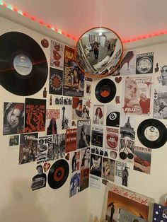 a room with various records on the wall and a disco ball hanging from the ceiling