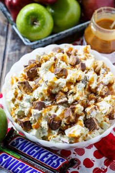 a bowl filled with food next to some apples