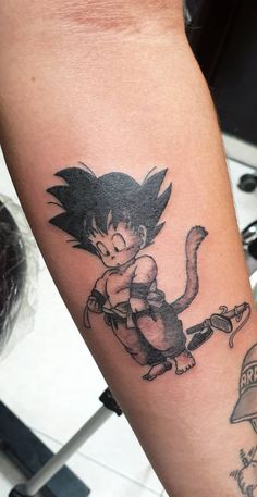 a person with a dragon tattoo on their arm and the image of a cat is in the background