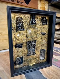 a framed display of jack daniels whiskey bottles