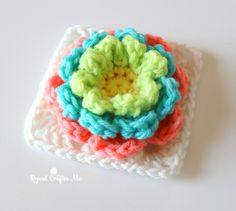 a crocheted square with a flower on it