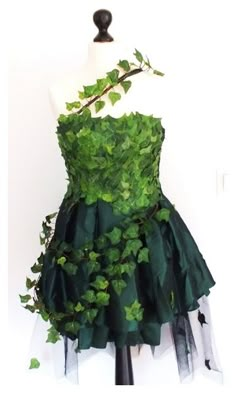 a dress made out of green leaves on a mannequin