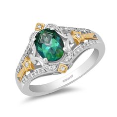 a ring with an oval green stone surrounded by two yellow and white gold leaves on the band